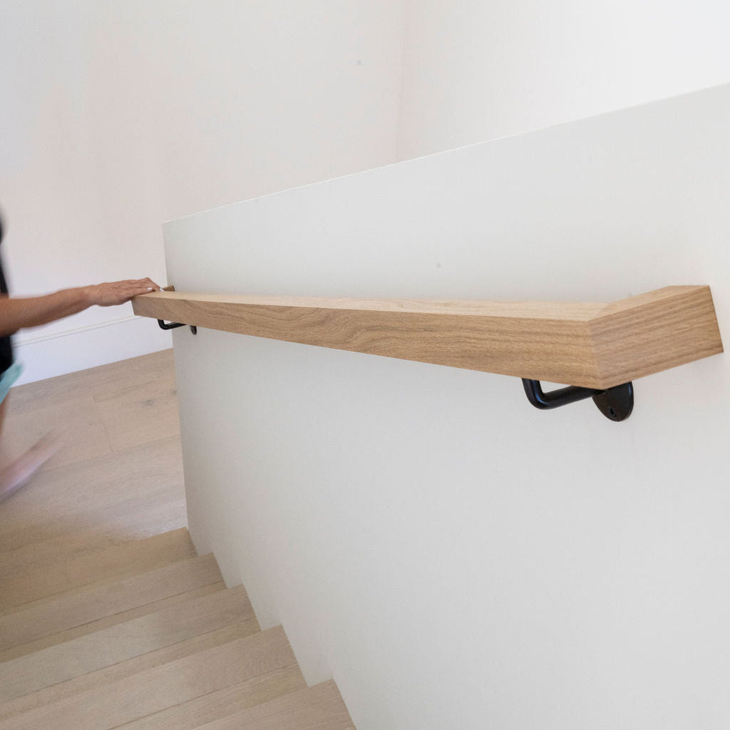 White Oak handrail installed on stairs.