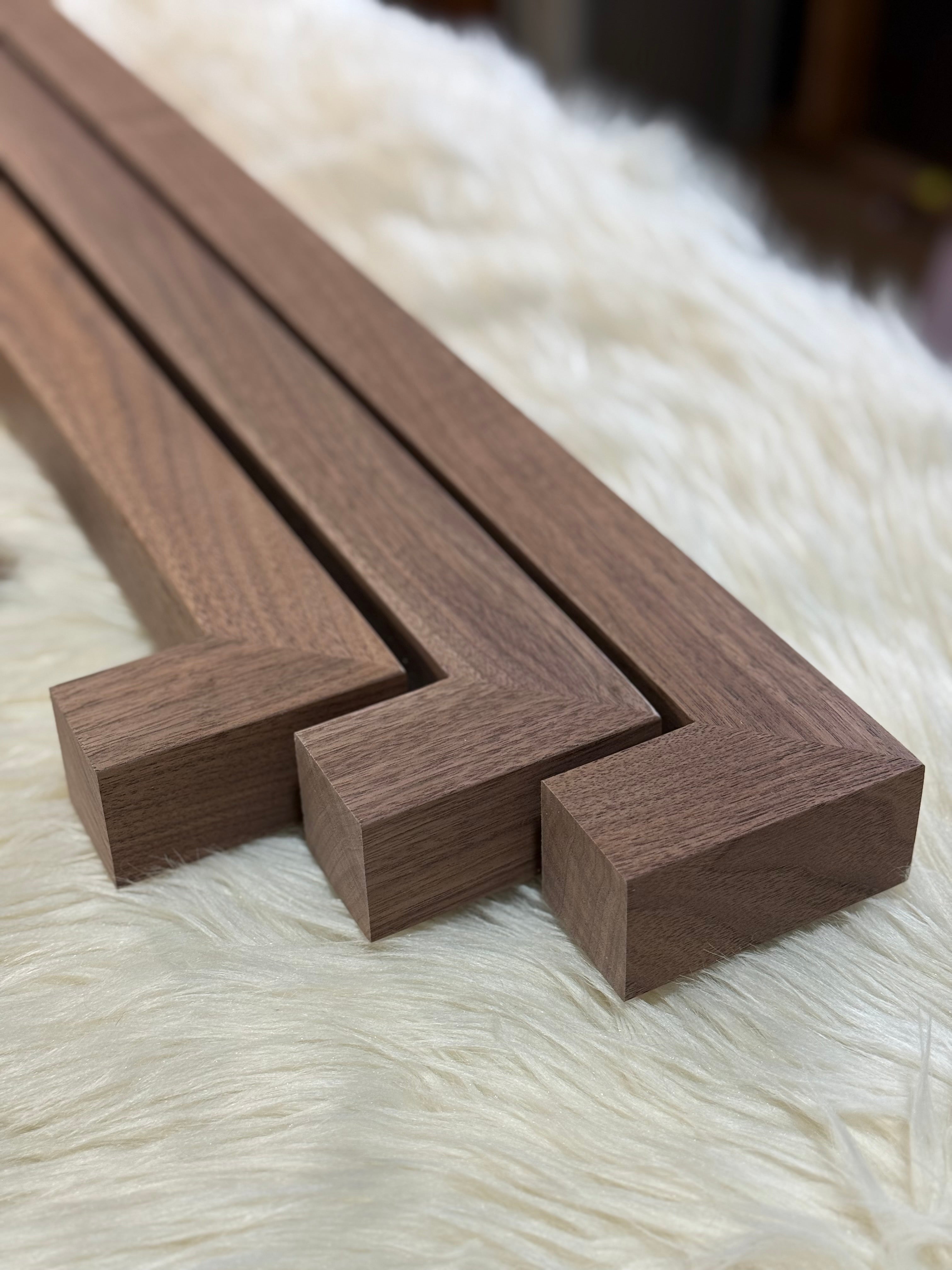 Dark walnut handrails laying on white fur rug