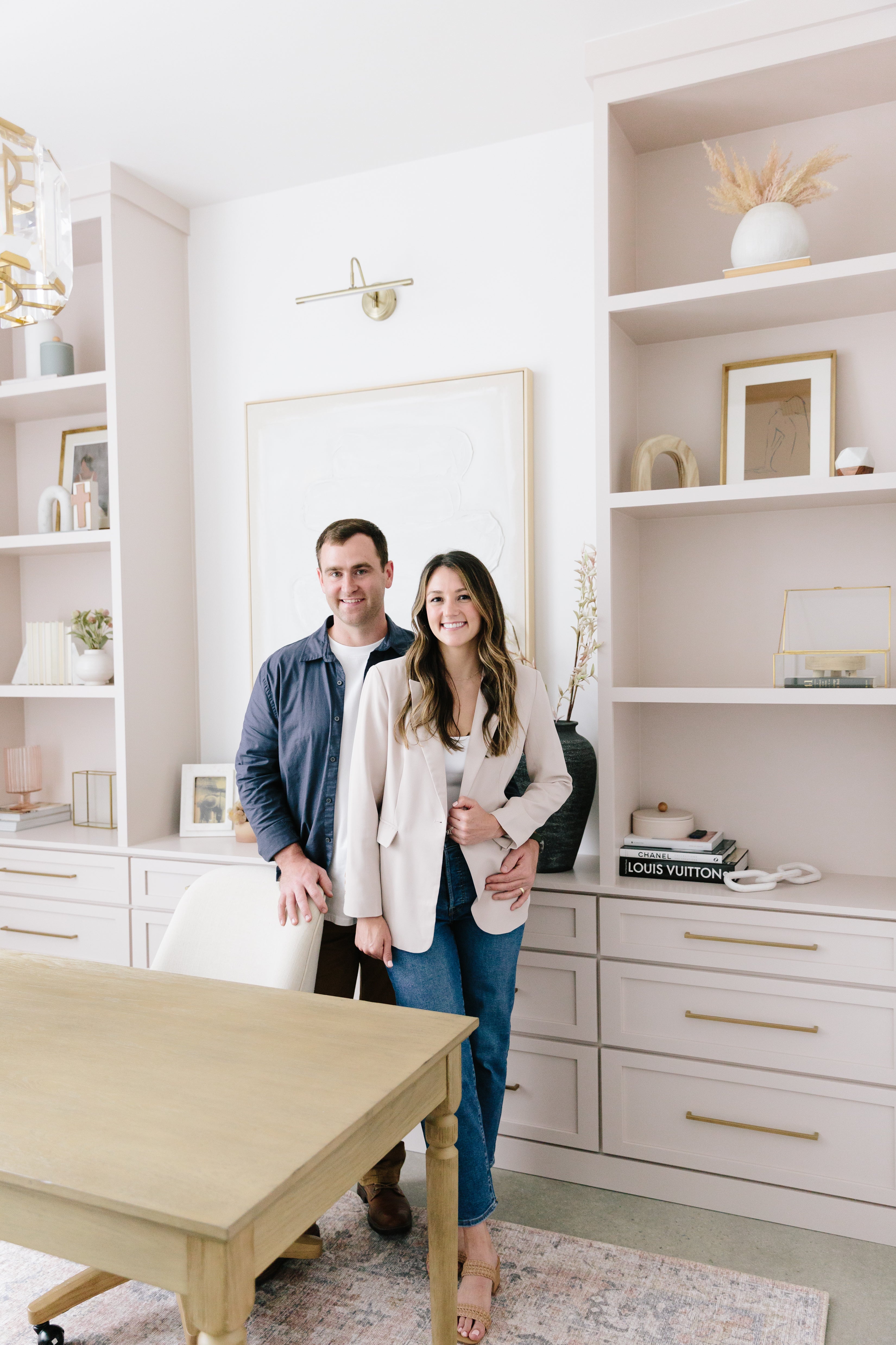 Matt + Hill with a built-in installed in Athens, GA. Blush with gold hardware, drawers on bottom & bookshelves on each side.