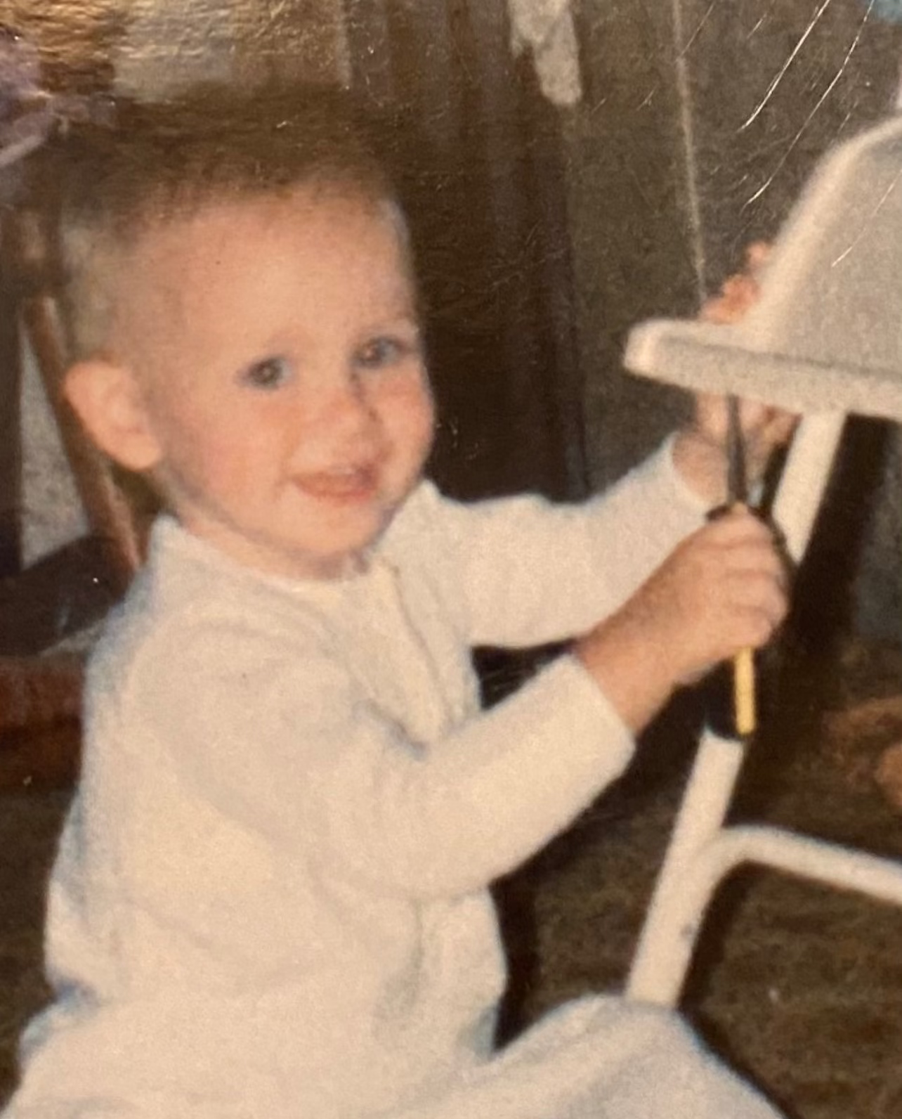 2 year old Matt with a crewdriver "fixing" a high chair