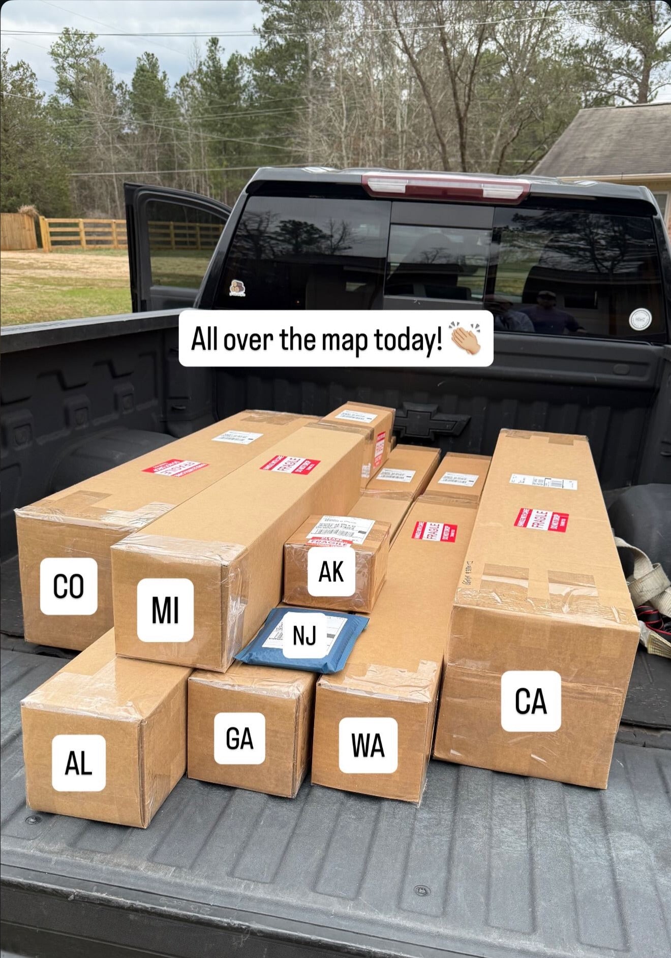 Orders boxed up in back of truck waiting for UPS to pickup. Boxes going to many US states -- CO, MI, AL, AK, NJ, GA, WA, CA.
